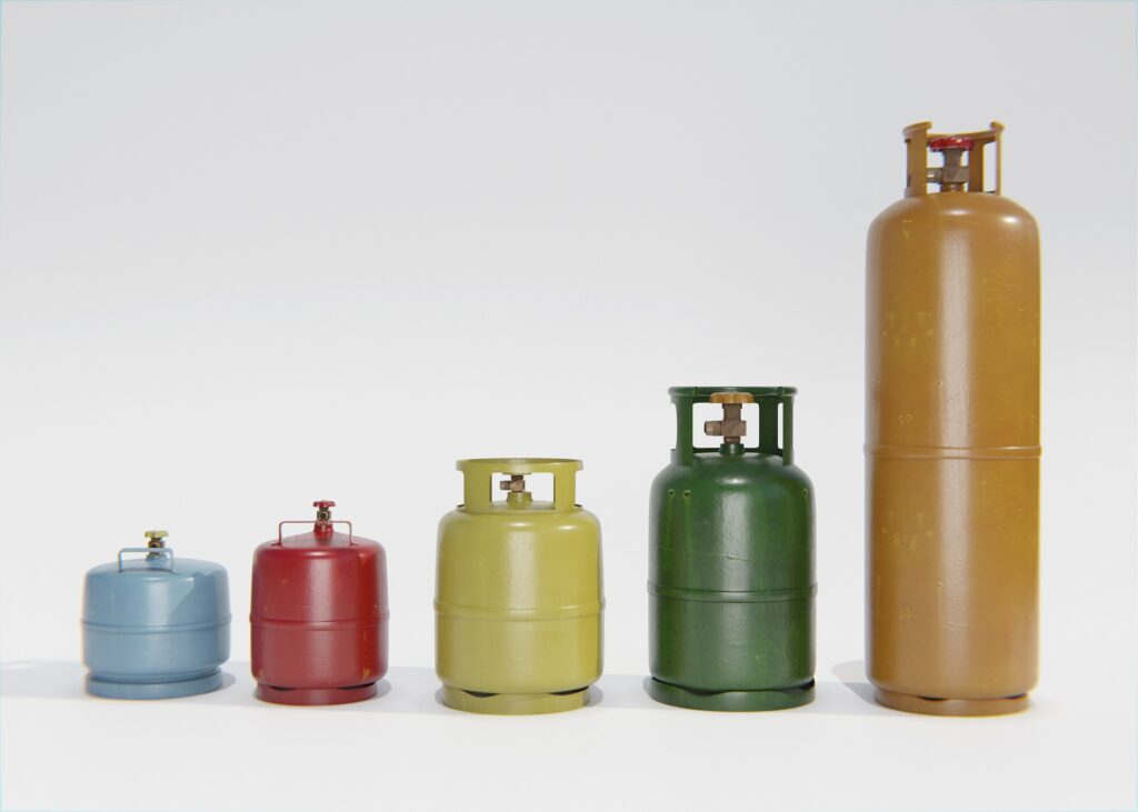 5 Gas Cylinders arranged in a row, From right to left the size of the cylinder is increasing